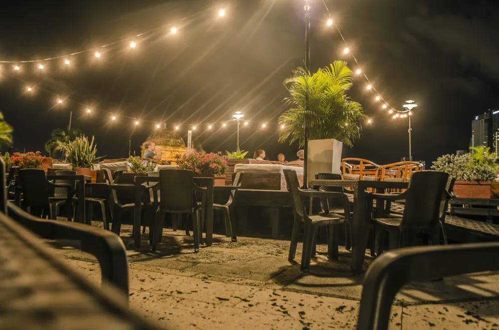 Bistro lights above outdoor dining tables