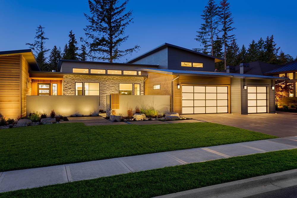 Exterior lighting along a modern home's facade and driveway