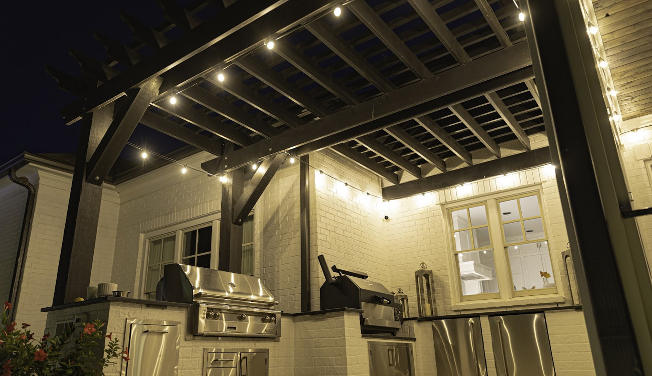 Warm string lights above covered outdoor seating
