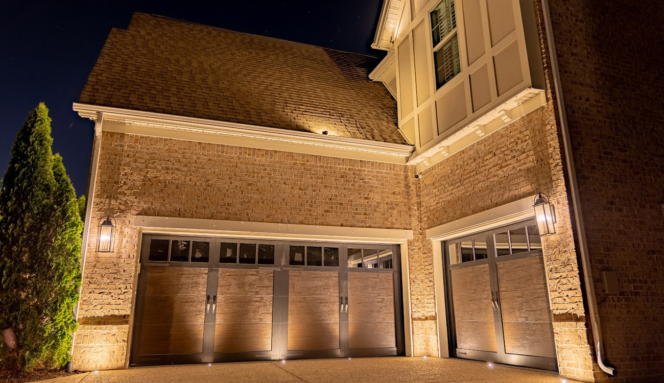 Wall lights illuminating brickwork above garage doors