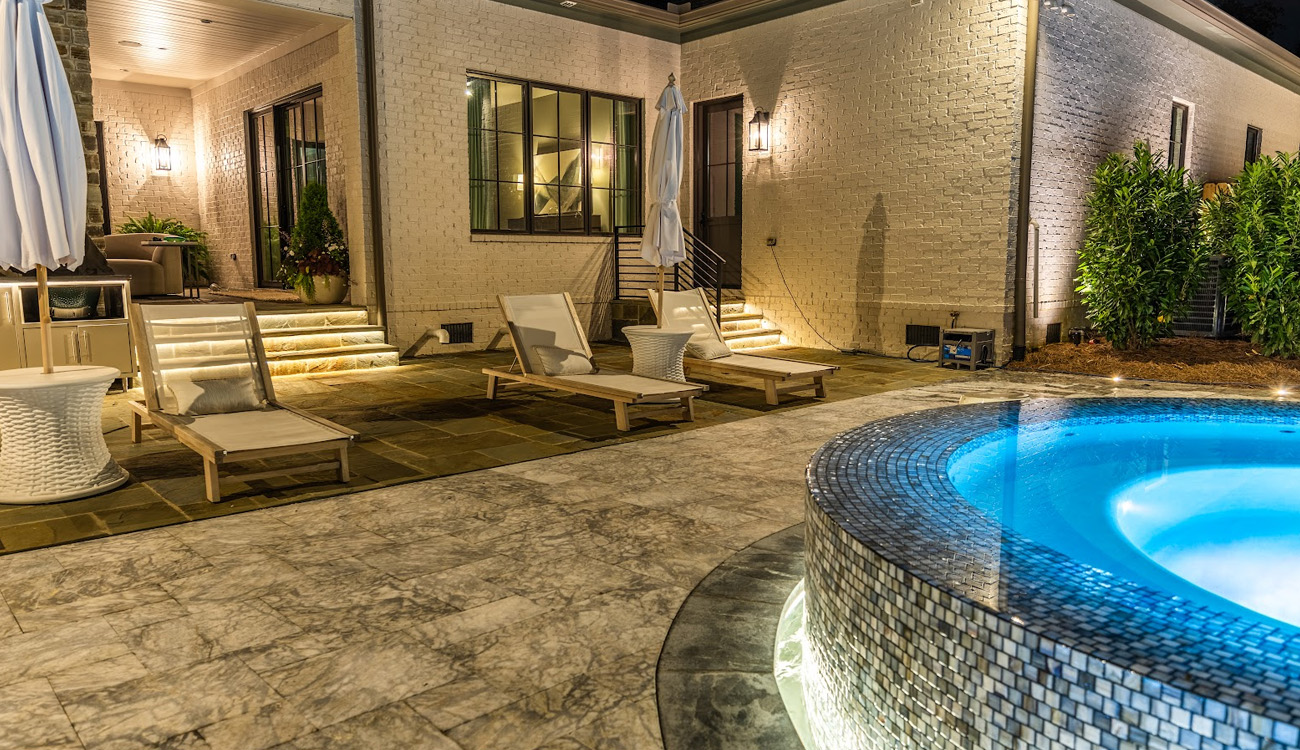 Wall lights above poolside patio seating
