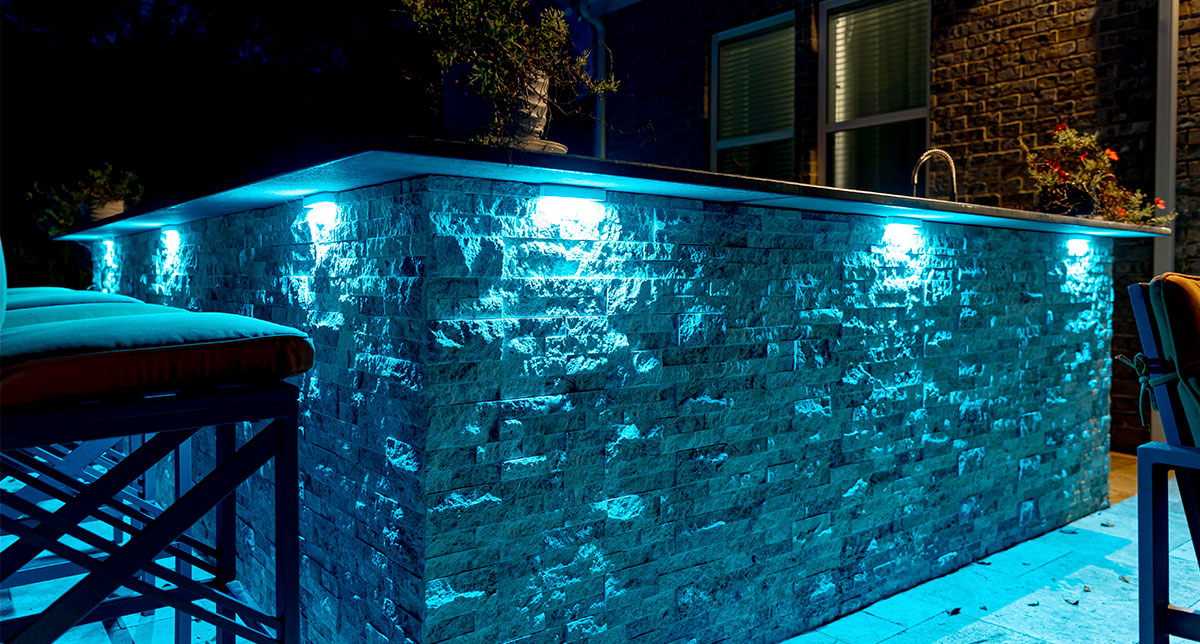Blue accent lighting on a stone pool wall