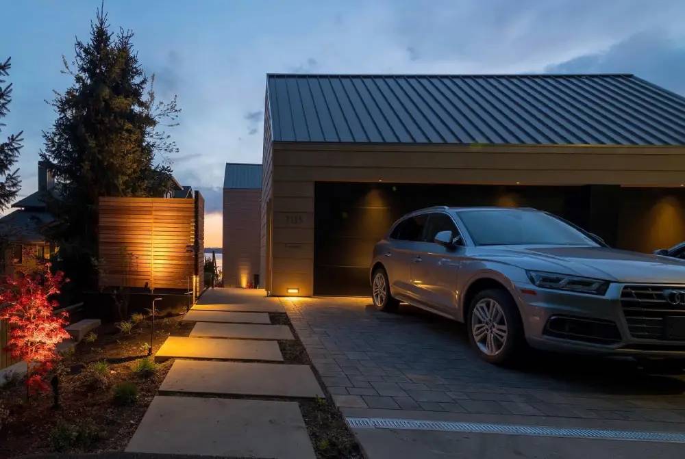 Lights illuminating a driveway and garage entrance