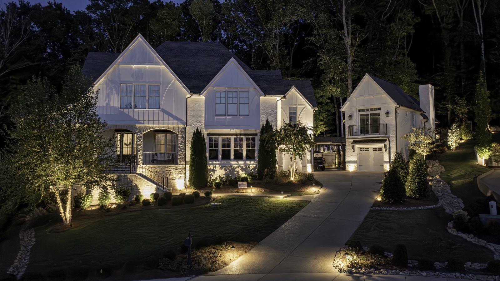 Illuminated home and landscaping at night