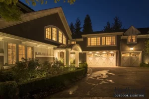 white and black home with exterior lighting